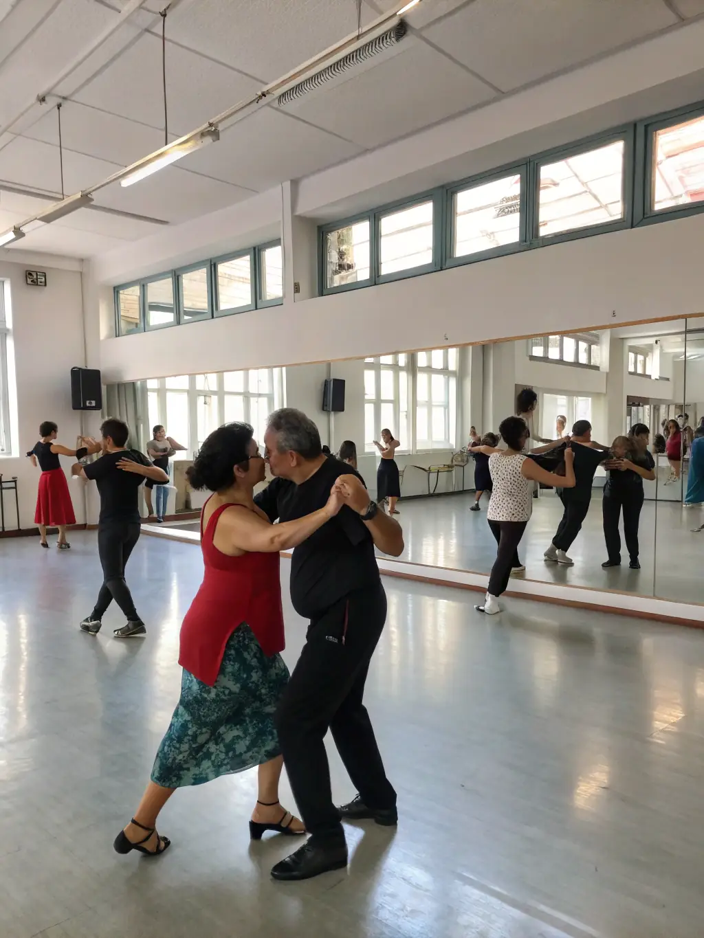 A dynamic image of a dance workshop in progress, with participants of various ages learning new moves and enjoying the rhythm of the music.